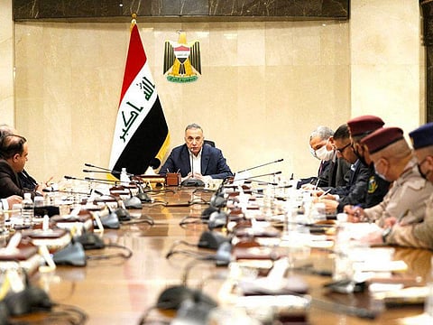 A handout picture released by Iraq's Prime Minister's Media Office on November 7 shows Iraqi Prime Minister Mustafa Al Kadhimi heading a meeting, hours after his residence was targeted by a drone attack, in the capital Baghdad.