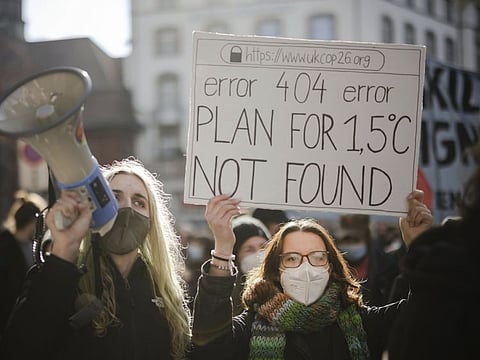 People attend a Climate Strike demonstration in Zurich, Switzerland, Nov. 6, 2021. The overarching phrase that dominates Glasgow climate talks is simply a number: 1.5. That's the chief but elusive goal of negotiations. It's keeping warming to 1.5 degrees Celsius since pre-industrial times.