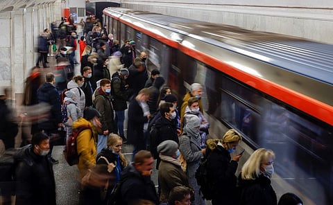 Passengers wait before boarding a train at Kurskaya metro station, after some of the partial lockdown measures imposed to curb the spread of COVID-19 were lifted by local authorities, in Moscow, Russia November 8, 2021.