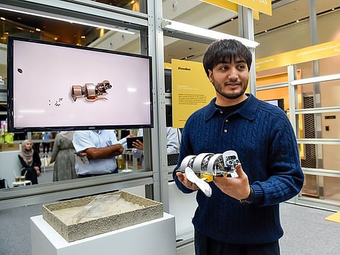 Mazyar Etehadi, a student of Dubai Institute of Design and Innovation, with his robot called A’seedbot, at Dubai Design Week at Dubai Design District on Monday