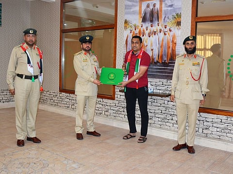 Mohammed Kafeel Addin Abdulghani being honoured by Dubai Police at Naif Police Station for his honesty.
