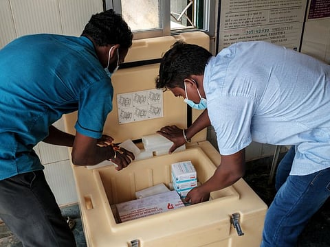 Hospital workers check supplies of the Bharat Biotech Covaxin and the Covishield, the AstraZeneca Plc vaccine manufactured by Serum Institute of India.