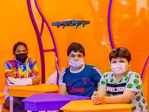 Children piloting drones at SIBF 2021 at Expo Centre Sharjah to learn about aerodynamics