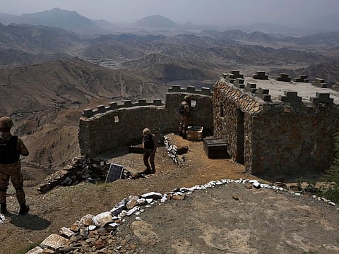 Pakistan troops observe the area from a hilltop post on the Pakistan-Afghanistan border, in Khyber district, in a file photo.