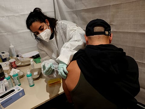 A healthcare worker administers a coronavirus disease (COVID-19) vaccine to a person at a walk-in vaccination centre at Alexa shopping mall in Berlin, Germany, November 9, 2021.