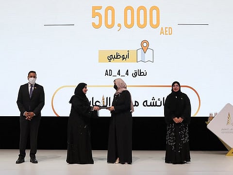 Ayesha Mohamed Al Zaabi winning the Golden prize in 'Distinguished Alef Cluster Leader' category of 2021 Alef Education Award in Dubai. Presenting the award is Jameela Al Muhairi, Minister of State for Public Education