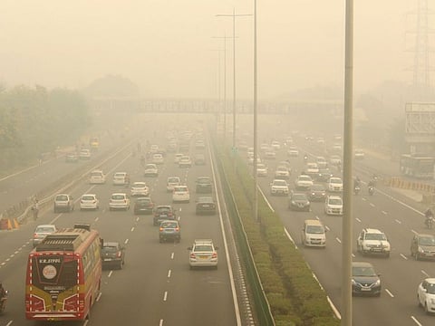 Vehicles ply amid low visibility due to a thick layer of smog at Delhi-Gurugram Expressway in Gurugram, Friday.