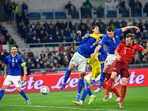 Italy's defender Giovanni Di Lorenzo (centre) scores an equalizer during the FIFA World Cup Qatar 2022 qualification Group C match against Switzerland at the Olympic stadium in Rome.