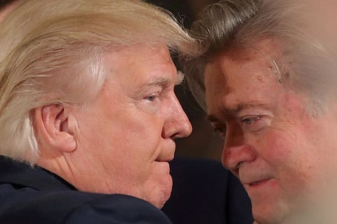 US President Donald Trump talks to chief strategist Steve Bannon during a swearing in ceremony for senior staff at the White House in Washington, US January 22, 2017.