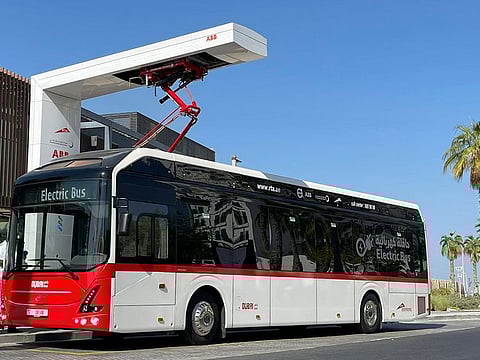 RTA electric bus charging under the arm of standing charger at La Mer Station
