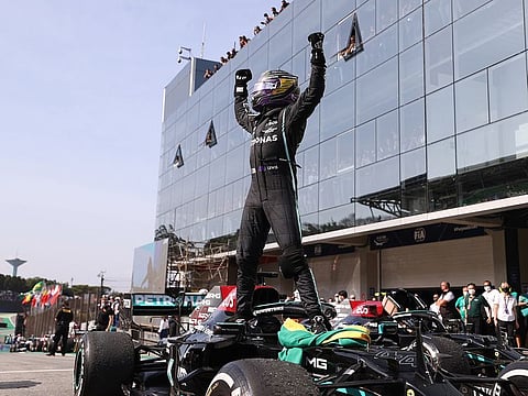 Mercedes' Lewis Hamilton celebrates winning the race.