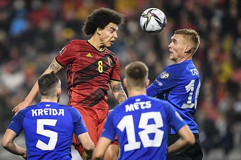 Belgium's midfielder Axel Witsel (left) fights for the ball with Estonia's defender Joonas Tamm (right) during the FIFA World Cup 2022 qualification match at the Baudoin King Stadium in Brussels.