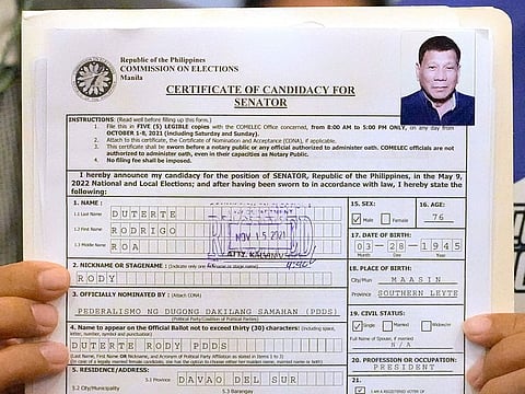 A representative of Philippine President Rodrigo Duterte holds his Certificate of Candidacy for Senator at the Commission on Elections in Manila, Philippines