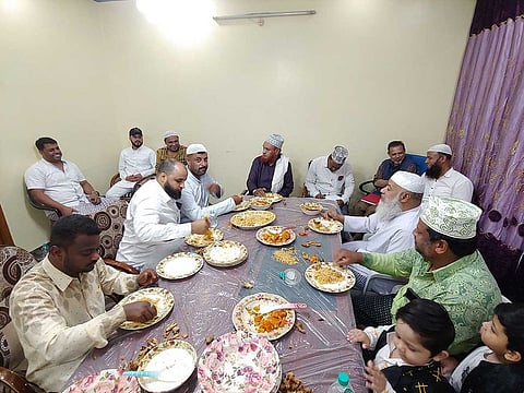 Friends share a meal at the Ba Oum home in Barkas, Hyderabad. Arabs from numerous tribes and countries made Barkas their home more than a couple of centuries ago.
