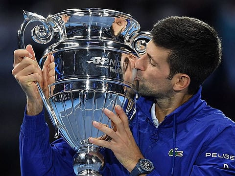 Serbia's Novak Djokovic celebrates with the ATP No. 1 player trophy after winning to Norway's Casper Ruud during their single match of ATP Finals in Turin