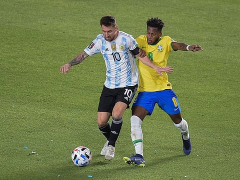 Argentina's Lionel Messi (L) and Brazil's Fred vie for the ball during their South American qualification football match for the FIFA World Cup Qatar 2022 at the San Juan del Bicentenario stadium in San Juan, Argentina, on November 16, 2021.
