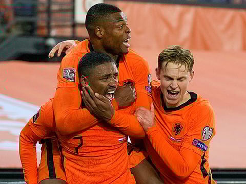 Netherlands’ Steven Bergwijn, bottom left, is congratulated by teammates after scoring his team’s first goal.