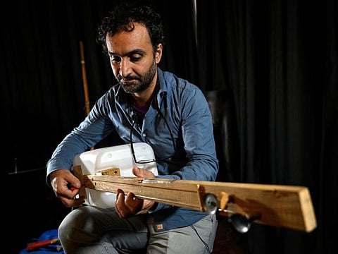 Fungistanbul band member Roni Aran plays one of his instruments made with waste in Istanbul.
