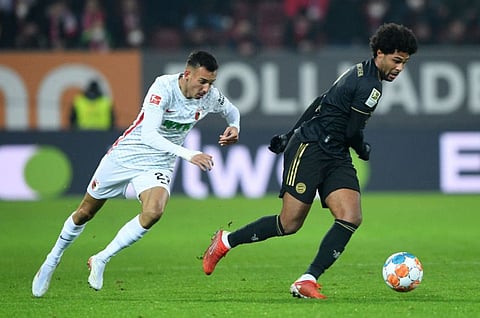 Bayern Munich's midfielder Serge Gnabry (right) and Augsburg's defender Amaral Borduchi Iago vie for the ball during the Bundesliga match in Augsburg, southern Germany.