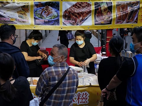 Vendors prepare orders for customers at a street market in the city centre, as coronavirus disease vaccination rates continue to rise, in Sydney, Australia, November 19, 2021.