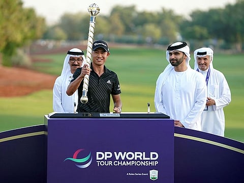 Sheikh Mansoor Bin Mohammed, Chairman of Dubai Sport Council (front right), Saeed Hareb (back right), Secretary General of Dubai Sports Council, Sultan Ahmed Bin Sulayem Group Chairman and CEO, DP World with Collin Morikawa of the US, who holds the winners' baton during the awards ceremony of the Dubai DP World Tour Championship at Jumeirah Golf Estates in Dubai.