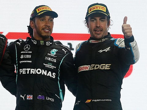 Mercedes' Lewis Hamilton celebrates on the podium after winning the race with third placed Alpine's Fernando Alonso. The Spanish former world champion was back at the podium after seven years.