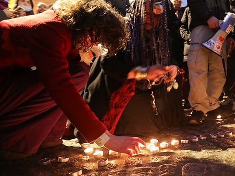 Protesters light candles as a ritual for a moment of silence, during demonstrations against coronavirus disease (COVID-19) measures in Amsterdam, Netherlands, November 20, 2021.