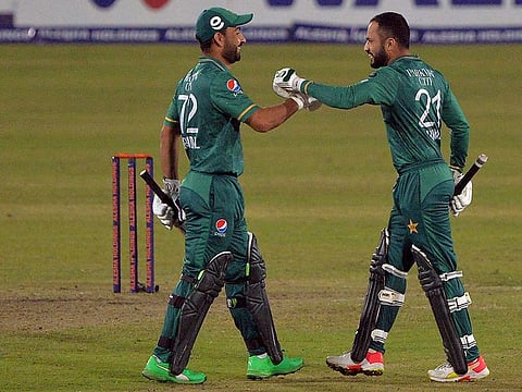 Pakistan's Mohammad Nawaz greets Khushdil Shah after winning the third T20 macth over Bangladesh