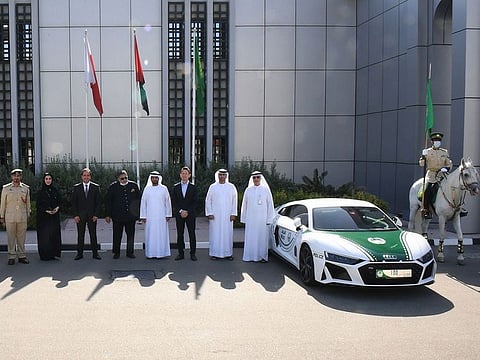 Representatives from Dubai Police and Al Nabooda Automobiles with the Dubai Police's Audi R8 Coupe supercar