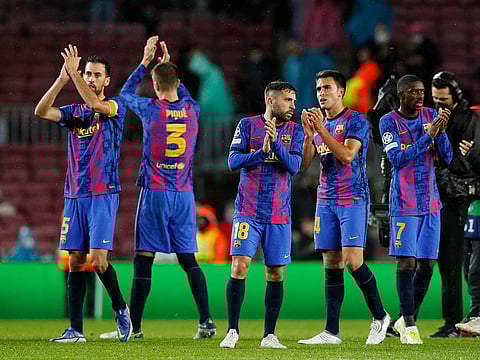 Barcelona's Jordi Alba with teammates applaud fans after the match.