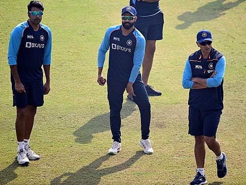 Spin twins: Ravi Ashwin (left) and Ravindra Jadeja at the nets with head coach Rahul Dravid in Kanpur.