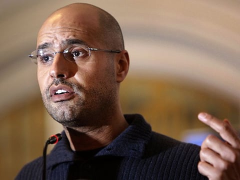 In this February 25, 2011, file photo, Saif Al Islam Gaddafi speaks to the media at a press conference in a hotel in Tripoli, Libya.