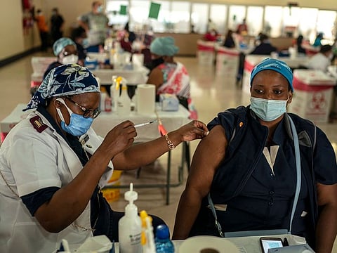 A health care worker is given the Johnson & Johnson COVID-19 vaccine at an assembly hall on the grounds of Charlotte Maxeke Johannesburg Academic Hospital in Johannesburg, South Africa, March 5, 2021.