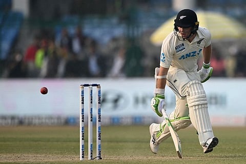 New Zealand's Tom Latham runs between the wickets on the second day of the first Test cricket match between India and New Zealand at the Green Park Stadium in Kanpur.