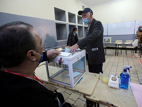 A man casts his vote during the local elections, in Algiers, on November 27, 2021.