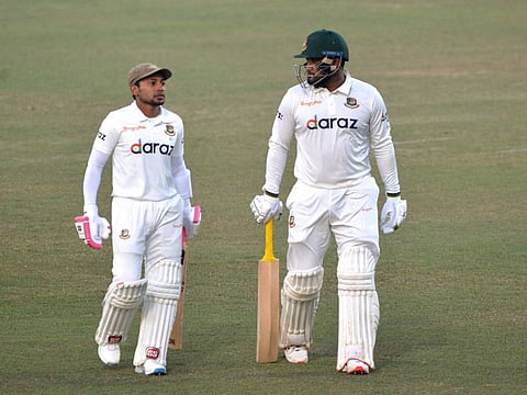Bangladesh's Mushfiqur Rahim (left) and teammate Yasir Ali walk back after the end of the third day play of the first Test cricket match between Bangladesh and Pakistan at the Zahur Ahmed Chowdhury Stadium in Chittagong.
