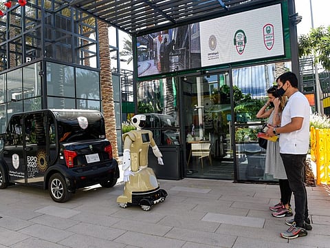 Visitors interacting with the Dubai Police robot at Expo 2020 Dubai.