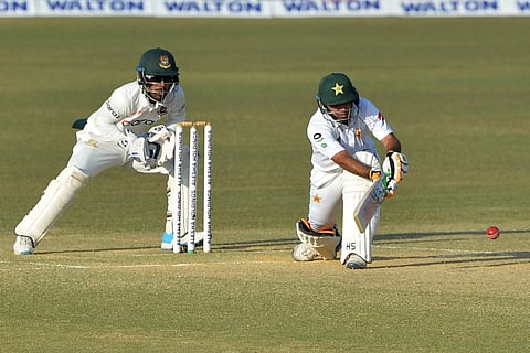Pakistan's Abid Ali (right) plays a shot as Bangladesh's wicketkeeper Liton Das watches on the fourth day of the first Test cricket match between Bangladesh and Pakistan at the Zahur Ahmed Chowdhury Stadium in Chittagong.