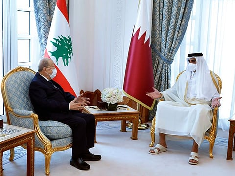 In this photo released by Lebanese government, Qatar's Emir Sheikh Tamim bin Hamad Al Thani, right, meets with Lebanese President Michel Aoun, in Doha on November 29, 2021.