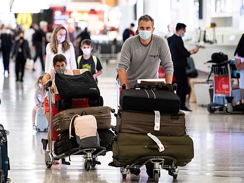 Travellers arrive at the international terminal at Sydney Airport on November 29, 2021.