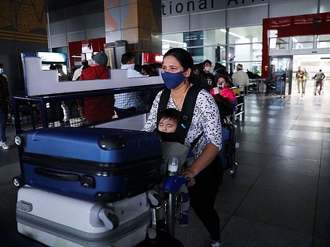 A woman exits from the arrival section of the Indira Gandhi International Airport in New Delhi, on November 29, 2021. Public health officials aim to analyse positive tests from airports within 48 hours and more than a dozen state-funded laboratories may be added to the current 38 that are part of the Indian SARs-COV-2 Genomics Consortium, or INSACOG.