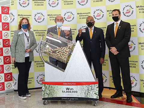 Dubai Duty Free representatives announcing the latest winner of the millionaire series 375 at Dubai International Airport on Tuesday