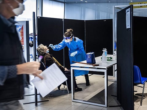 Travellers from South Africa are tested for COVID-19 on arrival in a specially designed test street at Schiphol airport, on November 30, 2021.