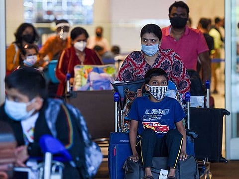Arriving passengers leave a terminal at the Chhatrapati Shivaji Maharaj International Airport in Mumbai on December 1, 2021.