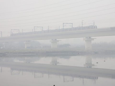 A metro train runs through the dense smog following the continuous drop in air quality to the 'Severe' category, in New Delhi on Thursday, Dec 2, 2021.