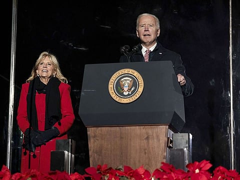 US President Joe Biden delivers remarks as first lady Jill Biden looks on at the 2021 National Christmas Tree ceremony on the Ellipse on December 02, 2021 in Washington, DC.