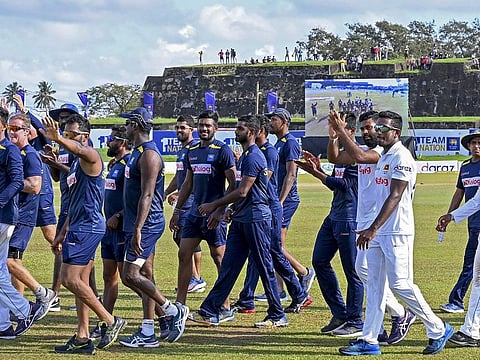 Sri Lanka's team members take a victory lap at the end of their second Test match against West Indies at the Galle International Cricket Stadium on Friday.