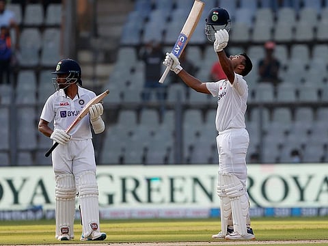 Mayank Agarwal's (right) reaction on reaching century says it all as non-striker Wriddhiman Saha applauds on the first day of second Test in Mumbai.
