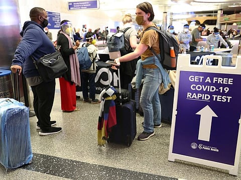 People who arrived on international flights wait to be tested on the first day of a new rapid COVID-19 testing site for arriving international passengers at Los Angeles International Airport (LAX) on December 3, 2021 in Los Angeles.