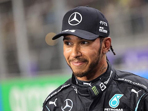 Mercedes' British driver Lewis Hamilton reacts in the parc ferme after taking pole position in the qualifying session of the Formula One Saudi Arabian Grand Prix at the Jeddah Corniche Circuit in Jeddah.